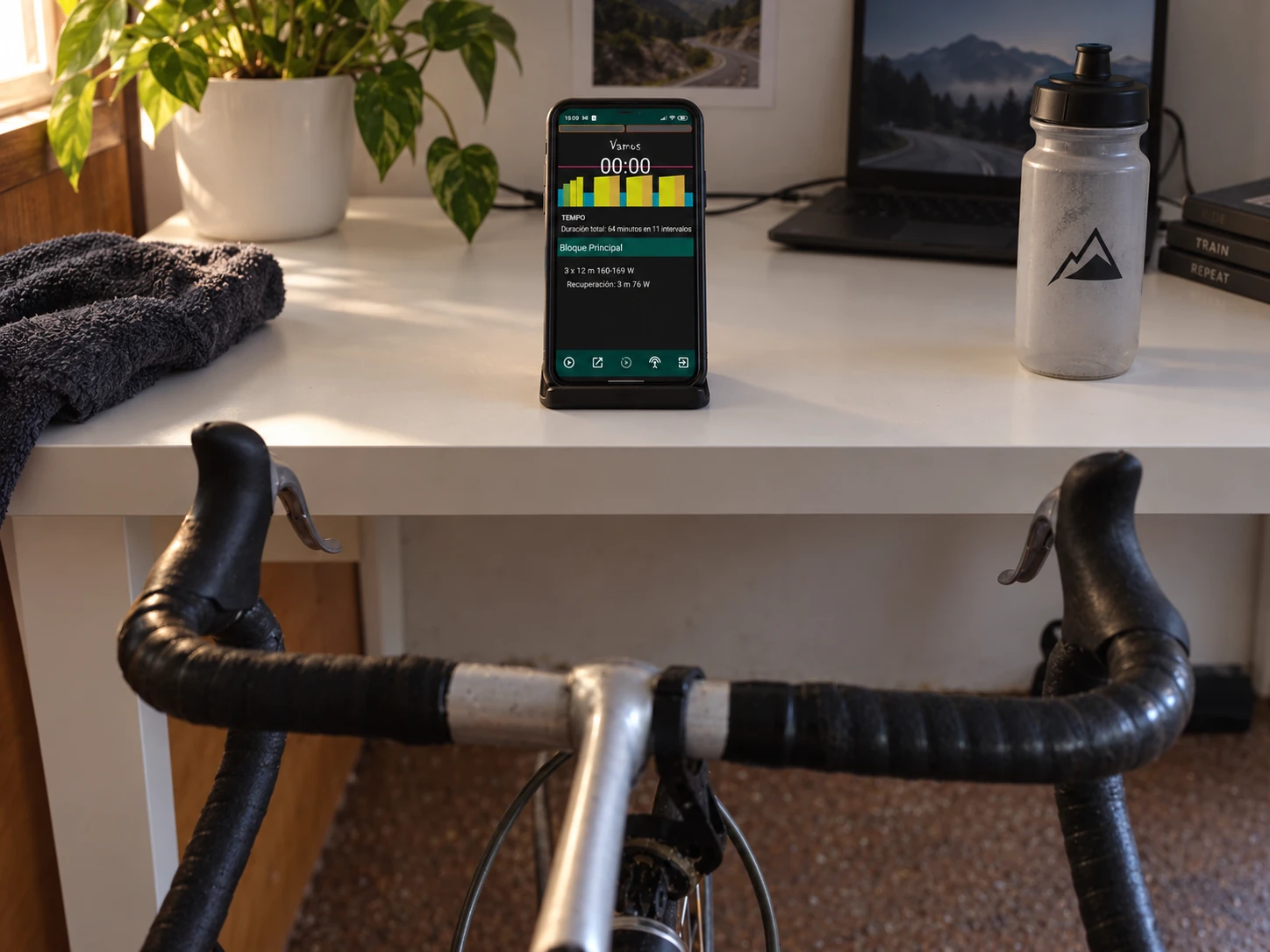 Phone showing Vin's old workout screen next to the bike in the cave, 2021